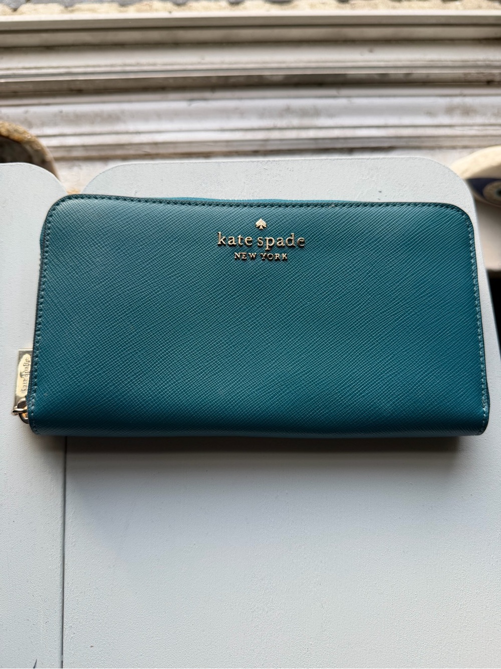 kate spade New York teal zip-around saffiano wallet with gold logo